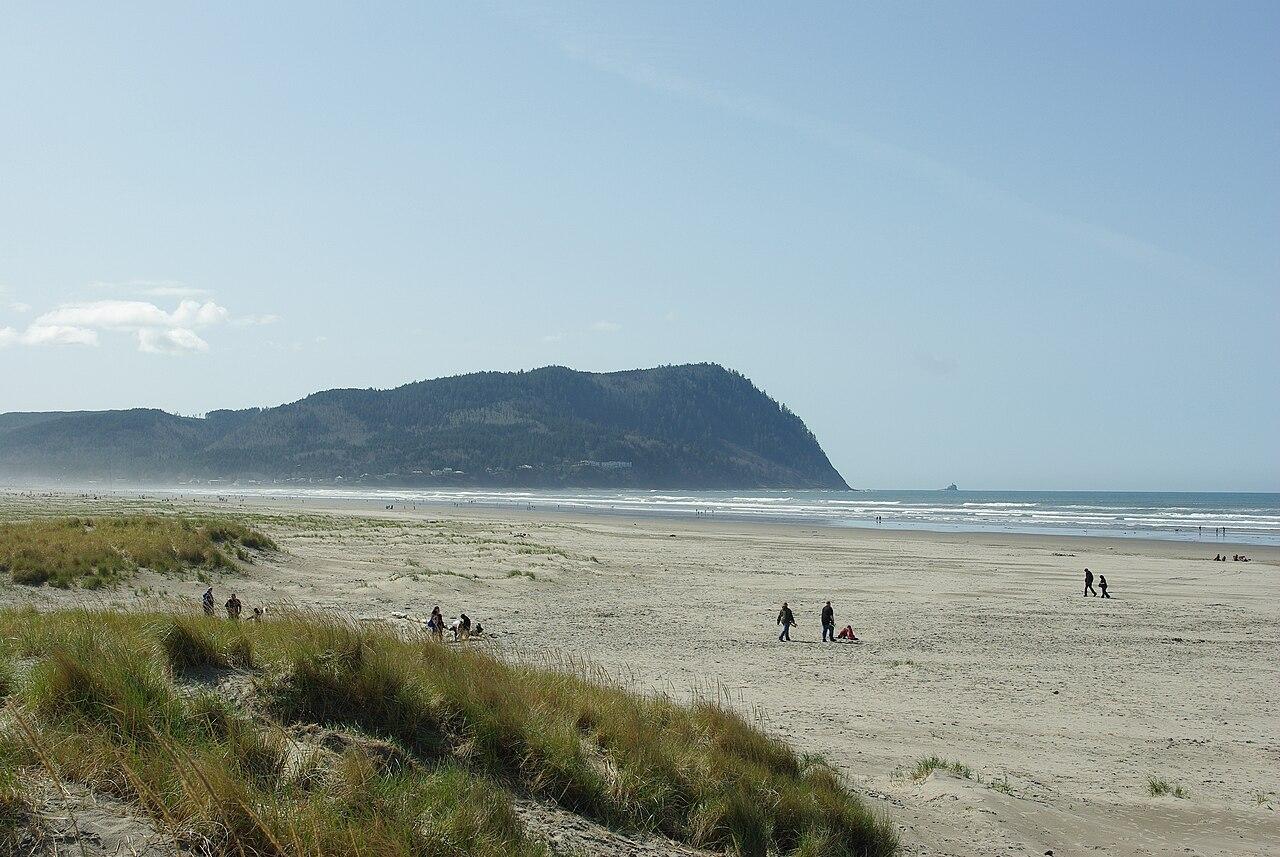Beach on northside of Seaside, Oregon, looking south with Tillamook Head in background.