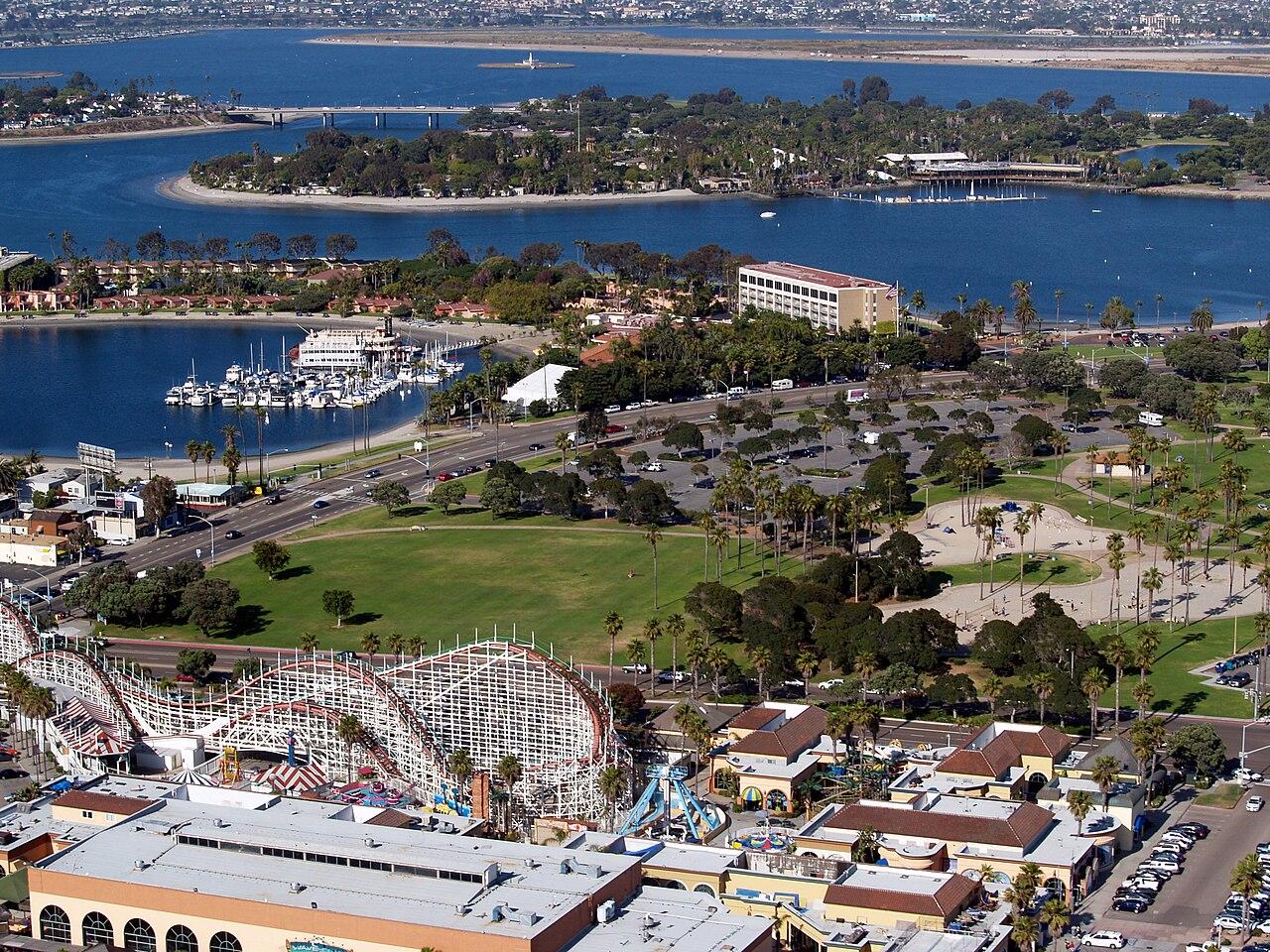 A photo of Mission Bay in San Diego, California looking to the east-northeast. Visible are the Giant Dipper Roller Coaster, Bonita Cove, Bahia Point, Vacation Island and Fiesta Island.
