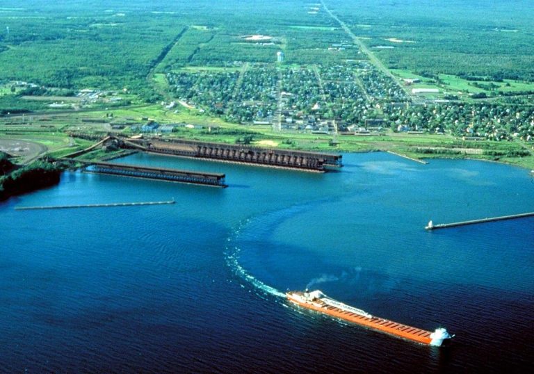 Aerial view of Two Harbors, Minnesota with a freighter departing the harbor.