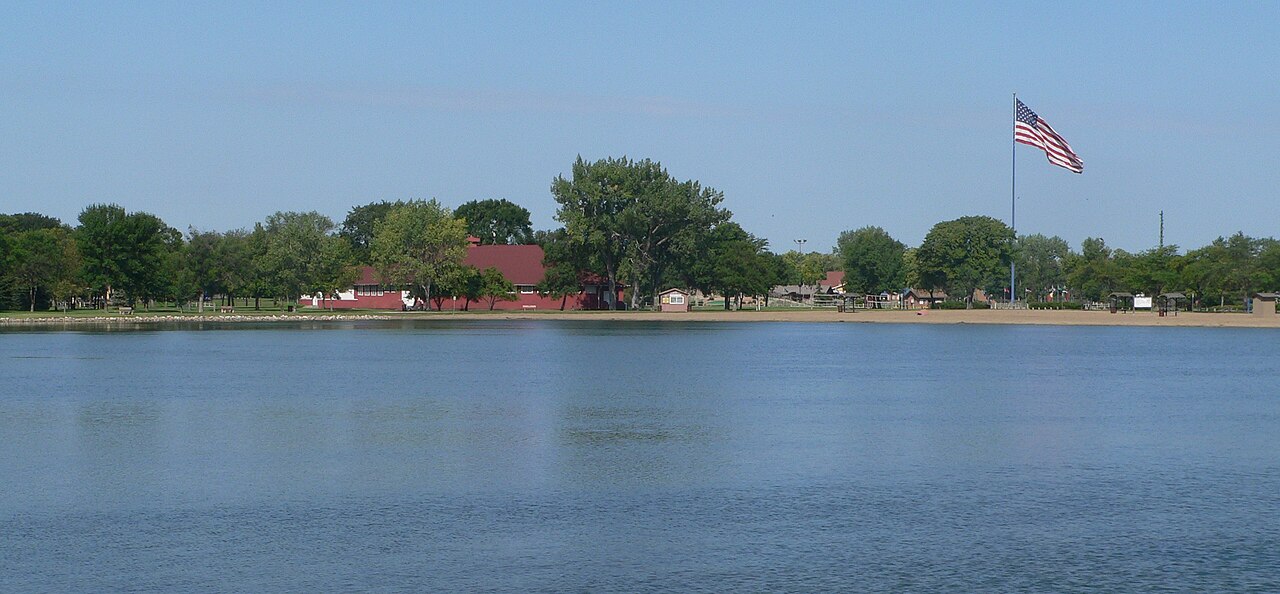 Wylie Park, located on west side of U.S. Highway 281 at the northwestern edge of Aberdeen, South Dakota; seen from the east, across the park lake.
