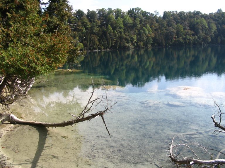 Deadman's Point at Green Lake in Green Lakes State Park, New York. "Marl reef", bacteria formed chalky shoreline formations, are visible in the foreground.