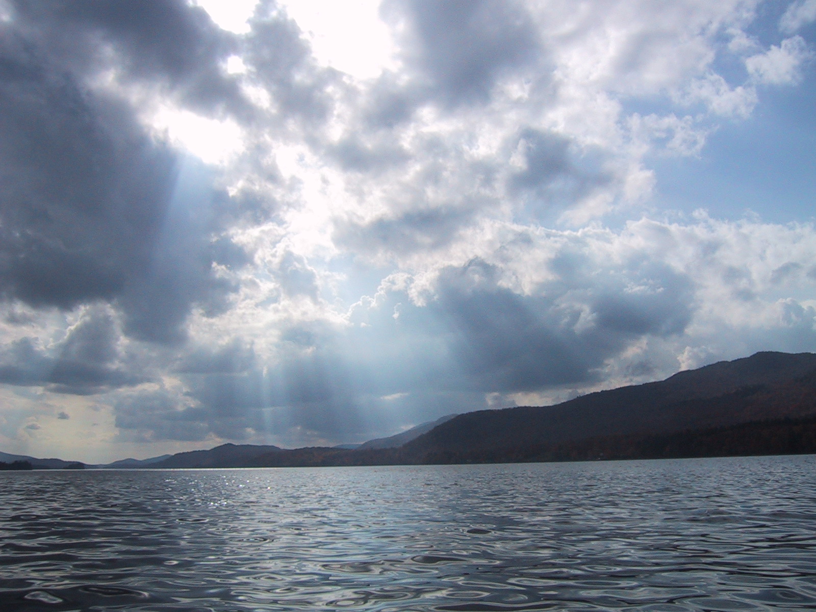 The sun coming in through the clouds on Indian Lake in upstate New York.