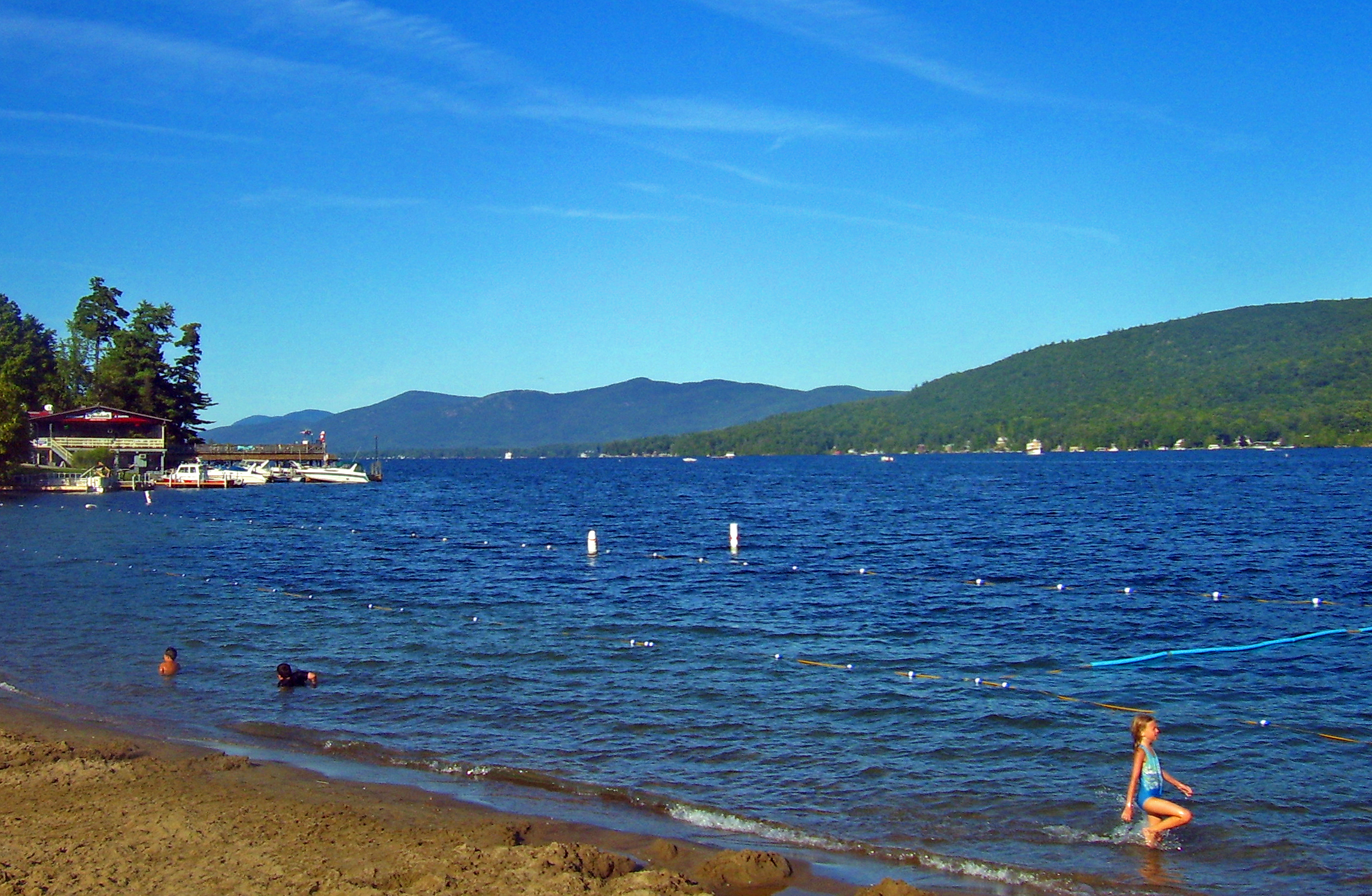 Lake George, NY, USA, from village beach at its south end. Shelving Rock, Buck Mountain and Pilot Knob in distance.