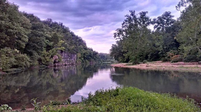 The Meramec River flowing past a wooded gravel bank in the state-park corridor